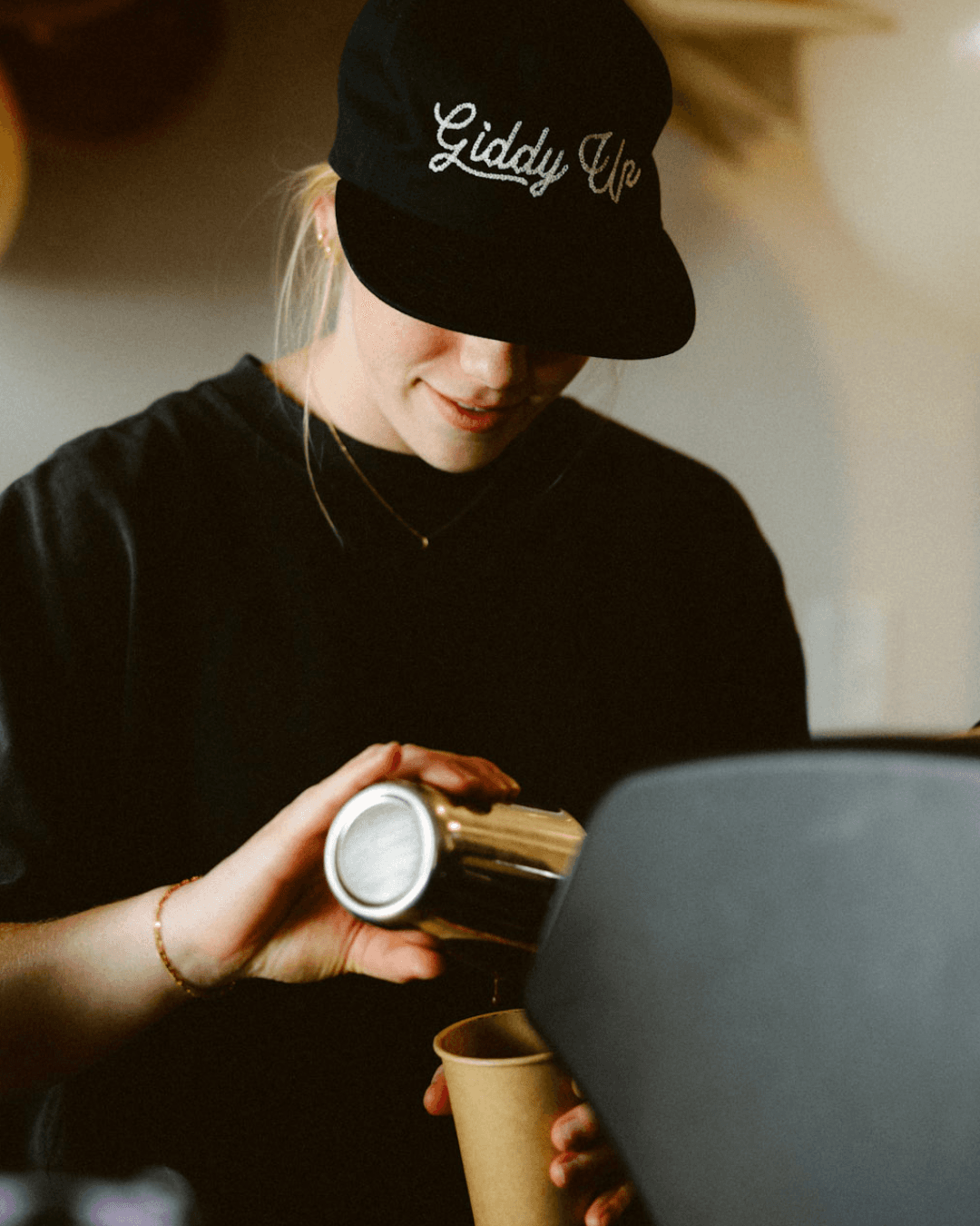 A friendly barista making a latte with a coffee cart